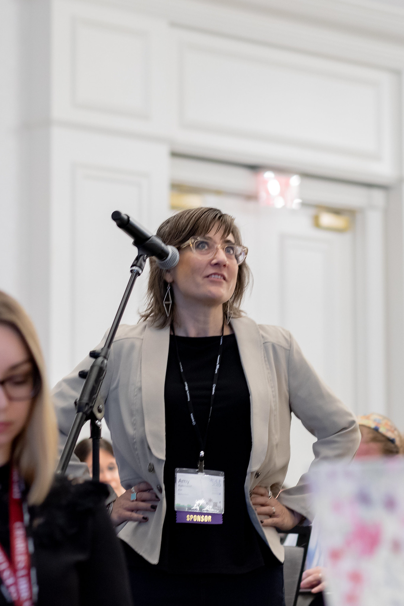 Woman stands at mic at 2019 Forum